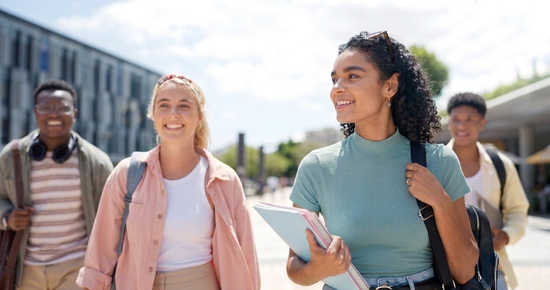 A diverse group of students walking together on a university campus